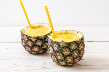 fresh pineapple smoothie glass on wood table