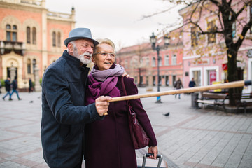 Fototapeta na wymiar Mature husband and wife enjoying together while walking in the city.