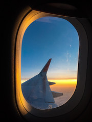 airplane wing with orange sunset