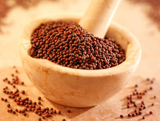 BLACK MUSTARD SEEDS IN PESTLE AND MORTAR
