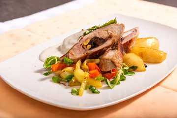 Royal file and potatoes sprinkled with white sauce with dried plums