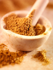 CUMIN POWDER IN PESTLE AND MORTAR