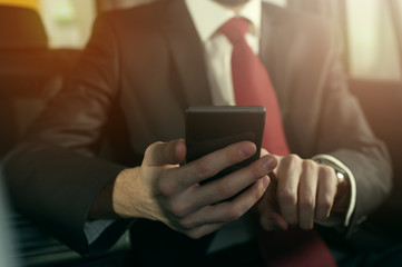 Close-up - young successful businessman sitting in the car