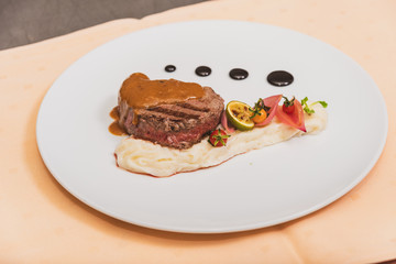 Pepper steak, served with potatoes, strawberry and cherry tomato