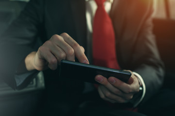 Close-up - young successful businessman sitting in the car