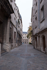 Narrow pedestrian street in an old city.