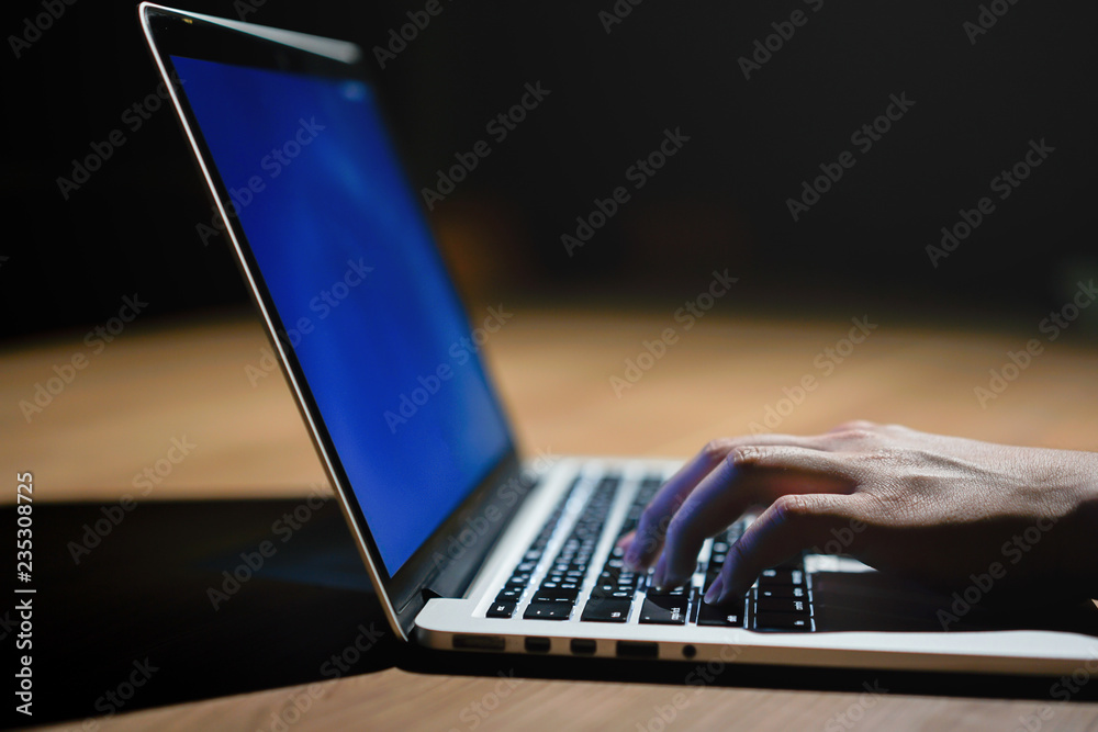 Wall mural close up businessman hand typing or working on laptop for programming about cyber security , advance