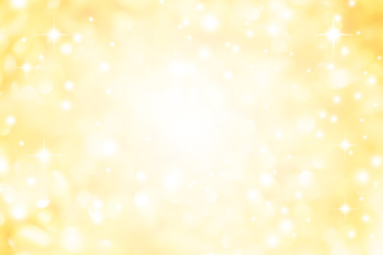 abstract blur glowing gold yellow color background with bokeh ,snow and shine star for merry christmas and happy new year	
