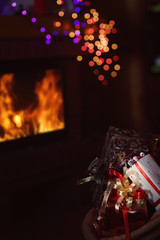 Fototapeta na wymiar bag of gifts in a warm hut on Christmas Eve
