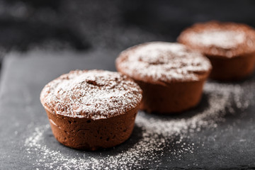 Classic chocolate fondant on a dark background. Chocolate muffins