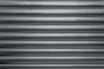 Fototapeta premium Abstract silver background with horizontal lines, lit with a soft light.