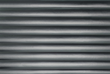 Abstract silver background with horizontal lines, lit with a soft light.