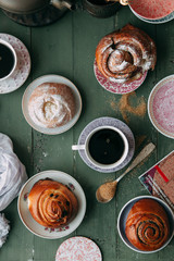 Buns and bread baking on dark wooden background. Food styling and cooking with fresh ingredients.
