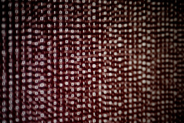 red binary code background. dangerous virus infection internet connection. computer errors and hacker breaching into the computer system. soft focus and surrounded by defocus bokeh.