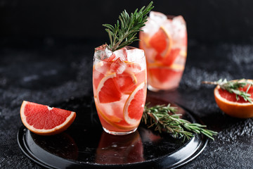 Fresh grapefruit cocktail. Fresh summer cocktail with grapefruit and ice cubes. Glass of grapefruit mojito
