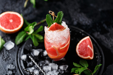 Fresh grapefruit cocktail. Fresh summer cocktail with grapefruit and ice cubes. Glass of grapefruit mojito