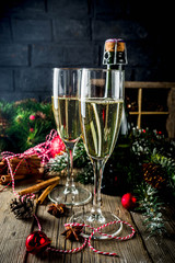Two glasses of champagne with Christmas decoration on wooden background, Happy New Year and Xmas Celebration. Copy space
