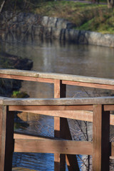 Wooden railing of the bridge close-up on the background of the river