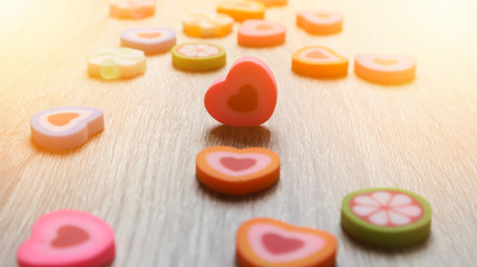 eraser hearts. Decorative colourful eraser is small heart shap on wooden blurred background. Valentine day concept.