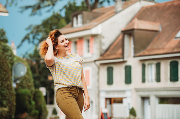 Fashion portrait of pretty young woman posing ouside, plus size model