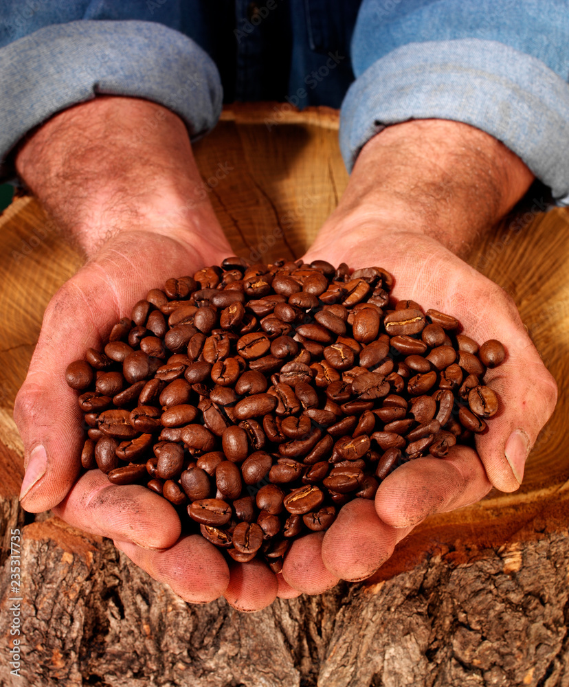 Poster man holding coffee beans.