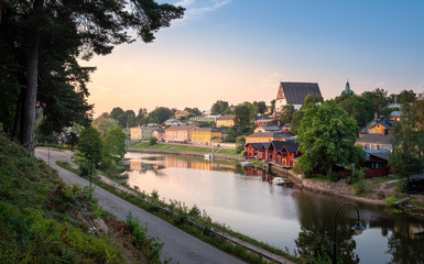 Fototapeta na wymiar Beautiful city landscape with idyllic river and old buildings at summer evening in Porvoo, Finland