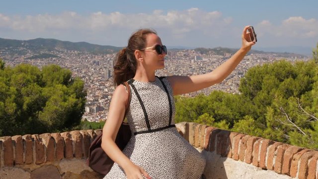 Tourist woman make selfie against Barcelona panorama