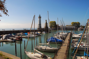 Fototapeta na wymiar Harbour entrance of Lindau, Lake Constance (German: Bodensee) with the new lighthouse and the Bavarian Lion