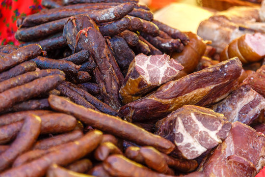 Smoked meat and sausages for sale on market.