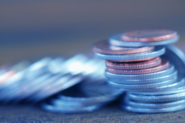 Row of coins on wood background for finance and Saving concept,Investment, Economy, Soft focus and dark style.