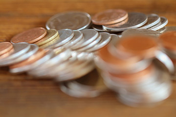 Row of coins on wood background for finance and Saving concept,Investment, Economy, Soft focus and dark style.