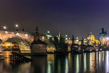 View of the Charles Bridge and Vltava river in Prague in a cold winter night - 5