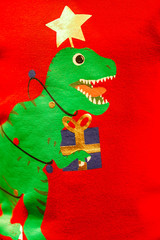 Creative green T-Rex Christmas tree print screen on on knitting sweater. © Surachetsh