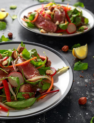 Spicy Beef Salad with Carrots, radish, bean sprouts, chilli, nuts and green mix
