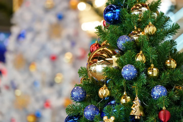 Christmas tree (white and green colour) and new year decoration in the department store.