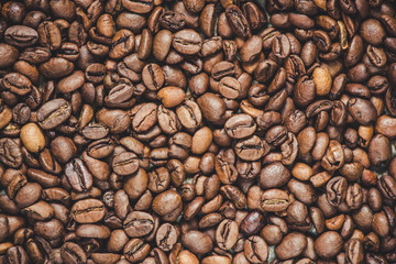 coffee grain (good and bad grain) - Arabica and Robusta blend (roasted coffee grain). Black background. Top view . Copy space.