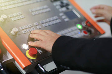 Hand of business man or sale operate bottom on machine control panel