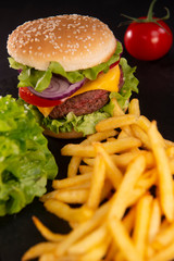 Burger with French fries cutlet with cheese and tomato
