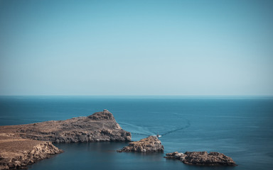 Small rocks go from sea next to Lindos town on Rhodes