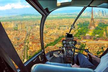 Helicopter cockpit aerial view of Tour Eiffel in Paris, French capital, Europe. Scenic flight above Paris skyline and cityscape, France.