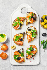Olives cherry tomatoes goat cheese bruschetta. Top view, space for text.