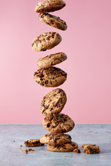 Chocolate chip cookies falling in stack
