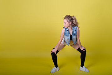 young attractive girl dancing twerk, shaking ass in shorts. copy-space