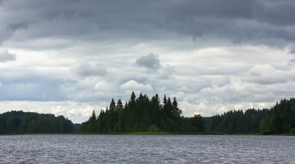 Dynamic Cloudy Sky Over A Forest Lake