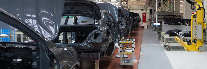 frame of car body. Long format. Wide angle view of plant of automotive industry. Can be used as banner