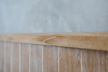 Light wooden bedhead and gray concrete wall, Loft interior design details, selective focus