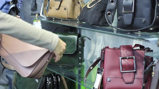Women's hands in the store choose a backpack