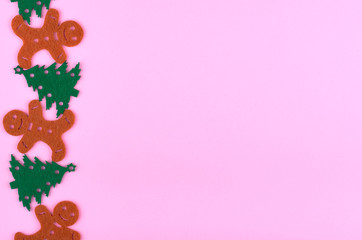 New Year composition with pine tree and gingerbread man. Christmas concept background. Flat lay, top view of festive still life