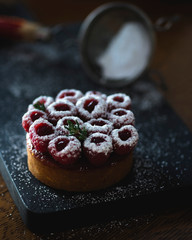 Raspberry tart on a cutting board