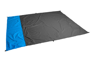 Waterproof and sandproof nylon beach blanket isolated on white background. Very thin tarp or footprint used for outdoor activities. Clipping path included. - obrazy, fototapety, plakaty
